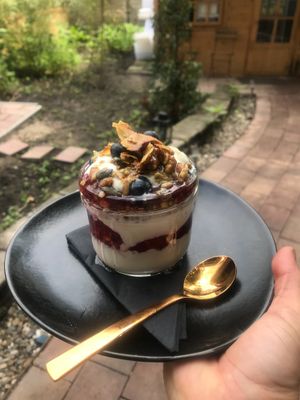 Matcha granola with Rhubarb, strawberry and vanilla compote, toasted coconut and almond yoghurt at Meatless District - Da Costabuurt in Amsterdam