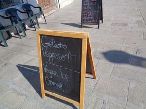 Signs advertising Gelateria al Sole's vegan ice cream and plant milks for your coffee. at Gelateria al Sole in Venice