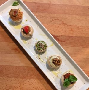 Staffed mushrooms with walnut meat, olive pate, pesto basil, tomato salsa, cashew mayo at Bistraw Zdravo Zivo in Skopje