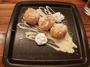 Sweet dumplings filled with apple and vanilla sauce at Vegana Indiana in Vienna