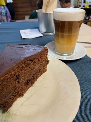 Chocolate cake and coffee with milk at Green Beans in Lisbon