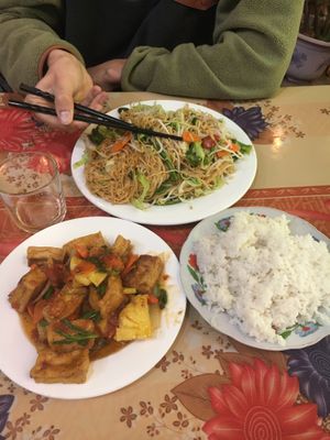 Country style tofu (tomato, pineapple, onion...) 40,000VND (small size) with rice 10,000VND in the front. In the back stir-fries noodles with vegetables 60,000VND (big size)  at Bao Anh in Ninh Binh