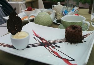 Molten chocolate cake, crème pot in the background at Olives Restaurante in Funchal