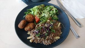 Main course (quinoa fritters, salad, lentils with veggies) at Terapija in Riga