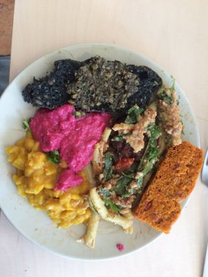 Sunday brunch with colored breads, beet hummus, curry, green beans with peanut butter.  at Terapija in Riga