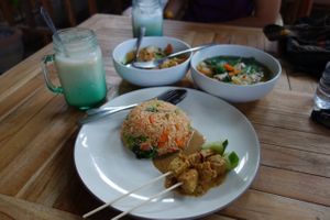Counter clockwise starting at the front: nasi goreng with satay, noodle soup, gado gado and banana juice at Bali Maitreya Cafe in Lembongan