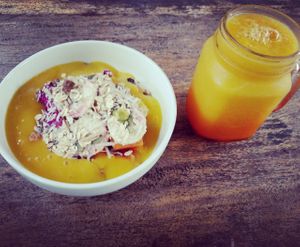 mango muesli fruit smoothie bowl with mango juice at Bali Maitreya Cafe in Lembongan