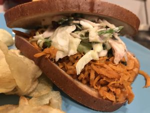Shredded pulled “pork”.... actually sweet potato!!! Homemade barbecue sauce, sweet with a little heat; and our famous kale slaw 😛 at SunShine Cafe - Front St in Keyport