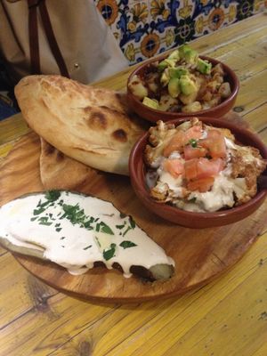 Special starter: eggplant with tahini sauce, cauliflower salad and potato salad with dried tomatoes at Pura Vida Vegan Bar in Madrid