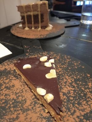 The peanut butter cake wasn't amazing, but the one behind was the best😍 (the tall cake, we don't remember what it was besides chocolate) at 26 Vegan Food Project in Lisbon