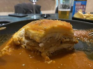 Cheese coated sandwich with in tomato soup (traditional Portuguese dish in vegan)  at 26 Vegan Food Project in Lisbon