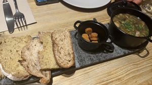Convert plate with nice bread, soup of mushrooms   at 26 Vegan Food Project in Lisbon