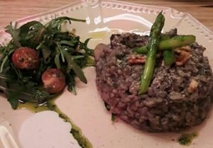 risotto and seitan steak in background at 26 Vegan Food Project in Lisbon