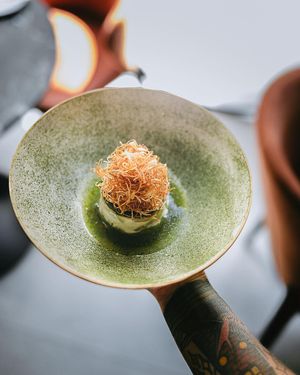 Candied jackfruit ceviche wrapped in yogurt mousse, seaweed hybrid sphere.
Finished with herbs, citrus and celery root straw. at 26 Vegan Food Project in Lisbon