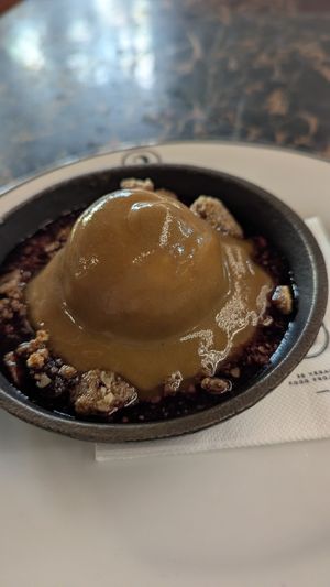 Berry crumble topped with ice cream and syrup at 26 Vegan Food Project in Lisbon