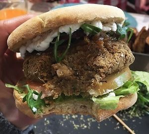 Meaty Lentils:  Burger Lentils on toasted Bolo do aco bread with Garli and herbs butter, arugula, caramelized onions, tomato and homemade Mayonnaise  at 26 Vegan Food Project in Lisbon