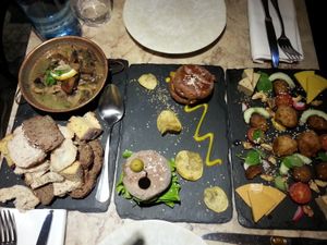 three starters: mushrooms, mini-burgers, vegan cheese and sausages  at 26 Vegan Food Project in Lisbon