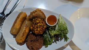 Mixed sides (Spring rolls, Curry puff, Corn fritter, Spicy tofu cake) $19.90 at Kindness Vegan in Darlinghurst