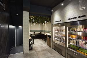 Inside shot of Rawligion including the beautifully cosy indoor garden area fully complete with USB & plug chargers under the tables plus complimentary wifi at Rawligion - Tottenham St in London