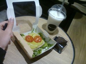 Breakfast with coconut smoothie, avocado sandwich, and chocolate cake! at Rawligion - Tottenham St in London