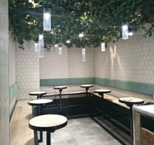 Indoor garden seating area at Rawligion - Tottenham St in London