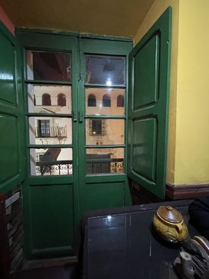 Windows look down onto the street and the Casa de la Moneda straight across   at Koala Cafe in Potosi