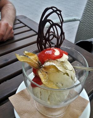 Ice cream ball - almond crisp, chocolate decorations, berries, caramel sauce, 4,50 euros at Kohvik Kroon in Parnu