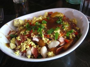 Breakfast poutine with extra vegan cheese and vegan bacon. It was pretty good, but way too salty for my taste buds. at L'Gros Luxe 100% Vege in Montreal