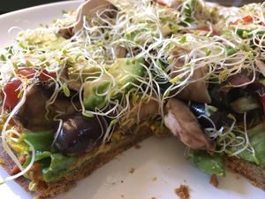 Vegan pizza with lots of toppings and great flavors  at Sweet Rawmance in Paris