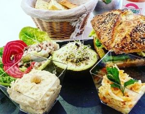 brunch 2/3 : a juice, burger, avocado ";fourré";, hummus and carrot tapenade, rice salad.  at Sweet Rawmance in Paris