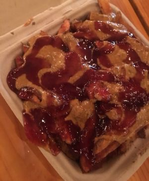 The famous PB&J fries-Hand cut fries, homemade satay and smoky raspberry chipotle sauces. So good at PBJ Grilled - Food Truck in Portland