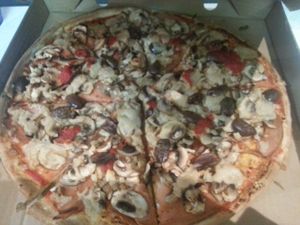 Vegan Capricciosa - vegan cheese, vegan ham, olives, mushroom at Eat Pizza - Flinders St in Melbourne