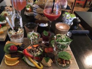 Vegan brunch. Lots of different veggies (and fruits), 2 kinds of hummus/spread, vegan yogurt, 2 salads, 2 kinds of bread, jam, housemade juice and soy latte.  at Onkel A in Vejle
