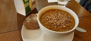 Vegan lentil soup and a piece of bread at SLA - Kerkplein in The Hague