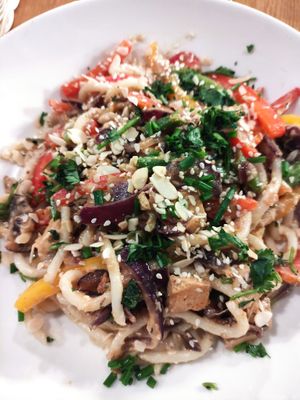 Udom noodles with stir fry vegetables and peanut butter and coconut sauce at Cocina Verde in Krakow