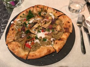 Pizza verde: green curry sauce, mushrooms, coconut cream at Mediamatic ETEN in Amsterdam