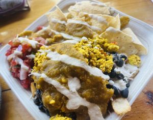 Breakfast bowl with beans, rice, tofu scramble, vegan cheese, pico & covered up in vegan green chili!🌶️   at The Corner Beet in Denver
