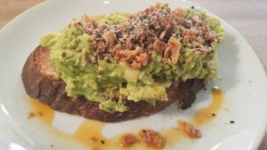 Smashed Avocado with miso butter, crispy onion, dukkah and chilli oil on sourdough at Waterloo Tea in Cardiff