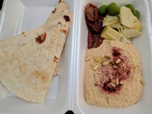 Hummus, olives, dry tomatoes and artichoke at Manna Manna in Brasov