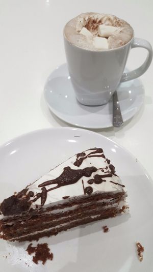 Chocolate cake and hot chocolate with cream and marshmallows. Luxurious! at Loving Hut - Southgate in Crawley