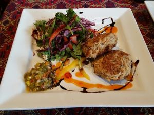 Parsnip Cashew Cakes- Sautéed chillies, leek, ginger and parsnip mixed with toasted cashews and almond flour. Pan seared until crispy served with pickled jalapeno salsa at Rebecca's Restaurant in Mahone Bay