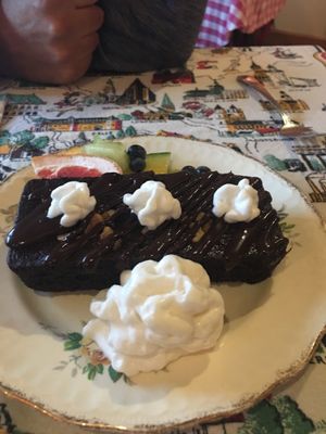 Chocolate brownie with chocolate sauce with coconut whipped cream - vegan  at Rebecca's Restaurant in Mahone Bay