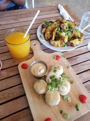 Orange juice, potatoes, yuca bites  at Holi Vegan Kitchen in North Miami Beach