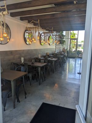 View from the entrance towards the parking lot at Holi Vegan Kitchen in North Miami Beach