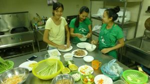 Parn training the staff in Phnom Penh at May Kaidee's Vegetarian Restaurant in Phnom Penh