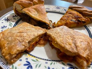 Puff pastry with tomato sauce, vegan cheese and onions, potatoes and yellow peppers pie, peppers and aubergines pie at Wani Vegan Bakery in Rome