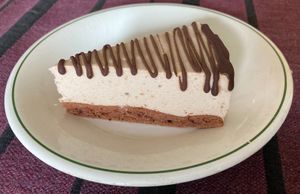 Banana mousse cake with dark chocolate garnish at Wani Vegan Bakery in Rome