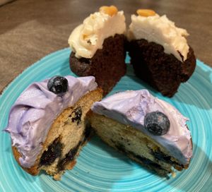 Chocolate cupcake with peanut cream frosting and blueberry cupcake, halved  at Wani Vegan Bakery in Rome