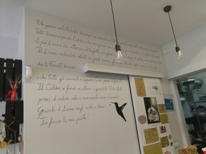 Inside wall close to the counter where you pay/their kitchen at Wani Vegan Bakery in Rome