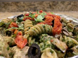 Pesto pasta + sun dried tomatoes + sunflower seeds + olives + cilantro at Ciao Italian Grill  in Oxnard